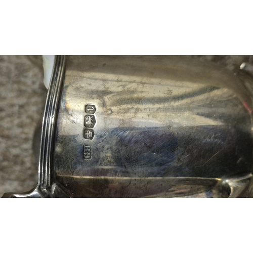 255 - A STERLING SILVER SUGAR BOWL Birmingham 1939 together with a sterling silver cream jug Sheffield 193... 