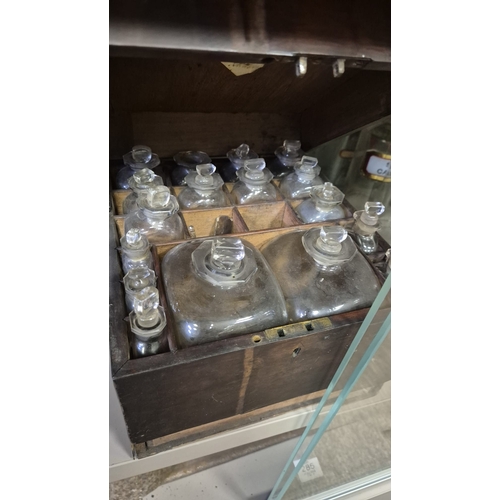 282 - A CASED APOTHECARY SET including numerous labelled vials, bottles, etc. Some still containing conten... 