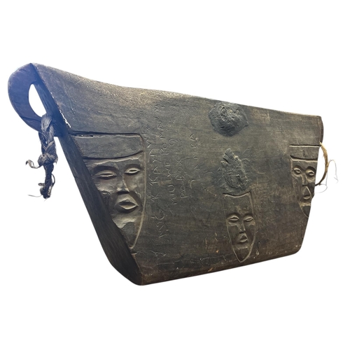 413 - A CONGALESE TETELA LUKOMBE SLIT DRUM bearing multiple carvings of human faces Approx. 132cm (h) x 62... 