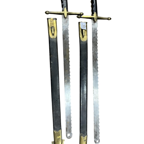 55 - A PAIR OF 19TH CENTURY SAWBACK SWORDS with single edged blades having sawbacks and rounded tips with... 
