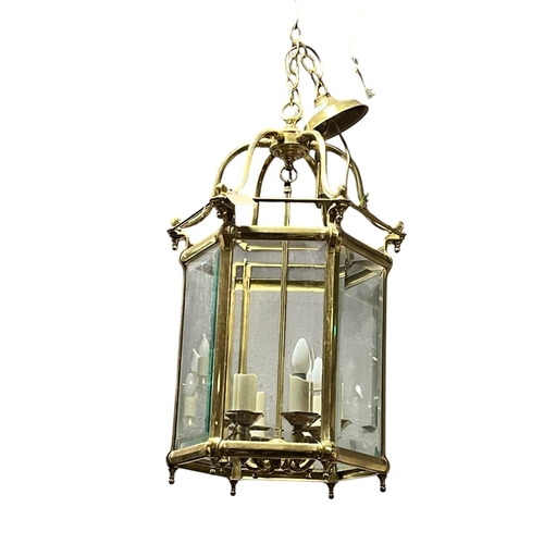 280 - A GEORGIAN STYLE BRASS AND GLAZED SIX LIGHT LANTERN of octagonal outline with bevelled glass panels ... 