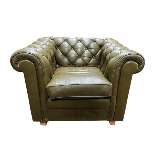 312 - A VICTORIAN STYLE GREEN HIDE UPHOLSTERED ARMCHAIR with deep buttoned upholstered scroll over back an... 