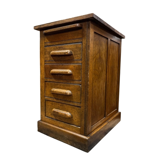 313 - A VINTAGE OAK CHEST of rectangular outline the shaped top above a brush and slide with four long gra... 