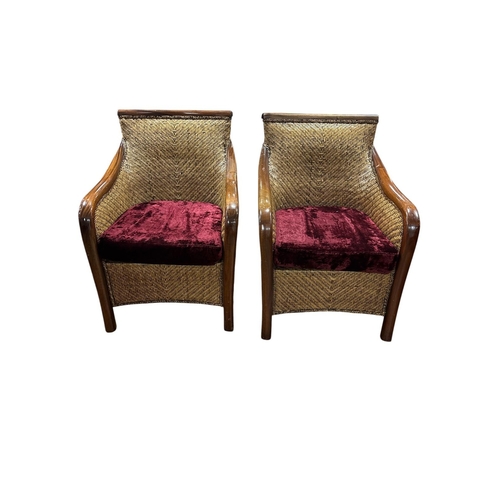 314 - A PAIR OF MAHOGANY AND RATTAN ARMCHAIRS the shaped back and seat with loose cushion on moulded legs