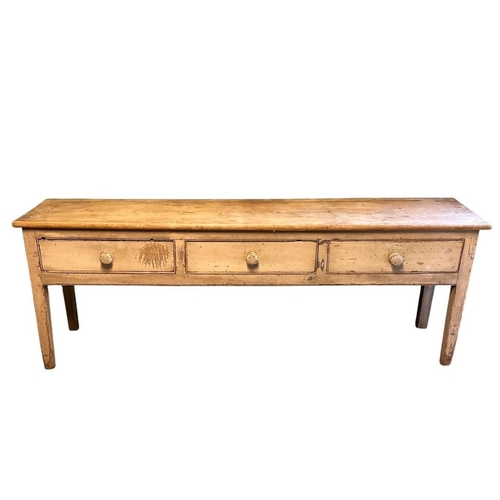 663 - A VINTAGE PINE AND PAINTED LOWBOY of rectangular form the shaped top above three long drawers with t... 