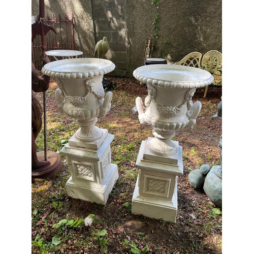 592 - A PAIR OF VICTORIAN STYLE CAST IRON GARDEN URN PLANTERS featuring outset lobed rims with applied mas... 