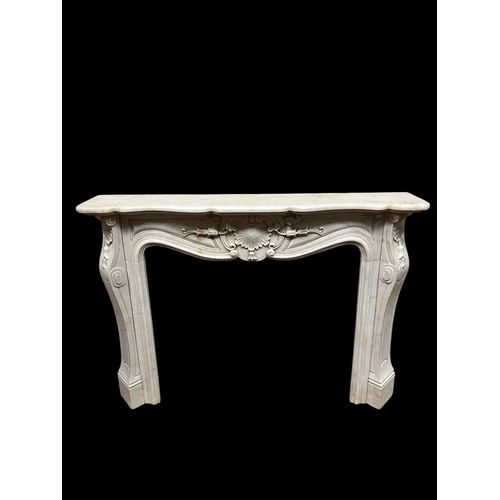337 - A CONTINENTAL WHITE MARBLE CHIMNEY PIECE the serpentine shelf above a shell and bell husk carved fri... 