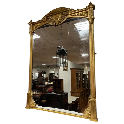 339 - A FINE 19TH CENTURY CONTINENTAL GILTWOOD AND GESSO MIRROR the shaped plate within a pilaster frame w... 