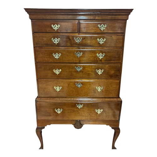 A VERY FINE IRISH WALNUT HIGH BOY CHEST ON STAND the flat top moulded cornice above two over five graduated drawers each fitted with pierced gilt brass keyhole escutcheons, backplates and handles featuring a centrally mounted carved shell apron raised on bracketed cabriole legs with carved paw feet 176cm (h) x 106cm (w) x 57cm (d)