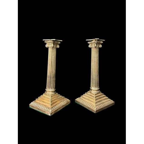 462 - A PAIR OF STERLING SILVER MOUNTED CANDLESTICKS London 1902 23cm (h) Total weight including filled ba... 