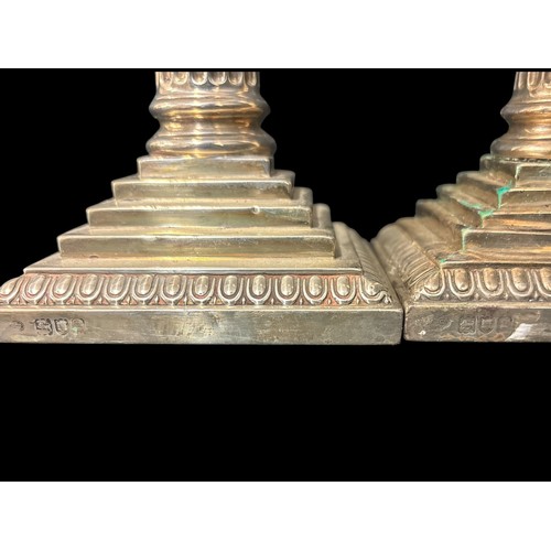 462 - A PAIR OF STERLING SILVER MOUNTED CANDLESTICKS London 1902 23cm (h) Total weight including filled ba... 