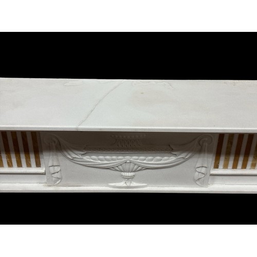 57 - A REGENCY STYLE WHITE MARBLE AND SIENNA INLAID CHIMNEY PIECE the rectangular stepped shelf above an ... 