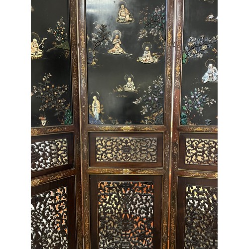 373 - A CHINESE LACQUERED BLACKWOOD FOUR FOLD SCREEN 19th century. Qing Dynasty. Solid top panels applied ... 