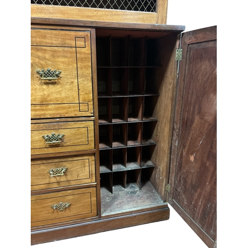 234 - A GEORGIAN MAHOGANY SECRETAIRE BOOKCASE the moulded cornice above a pair of brass grill doors contai... 