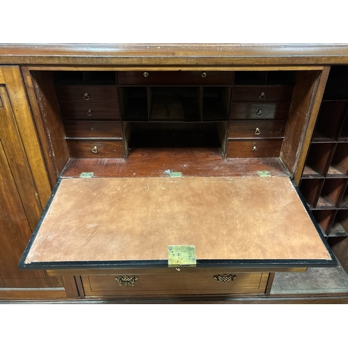 234 - A GEORGIAN MAHOGANY SECRETAIRE BOOKCASE the moulded cornice above a pair of brass grill doors contai... 