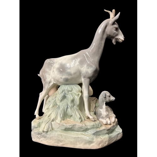 273 - A LARGE LLADRO PORCELAIN FIGURAL GROUP of shepherd sleeping alongside a nanny goat, kid and dog 36cm... 