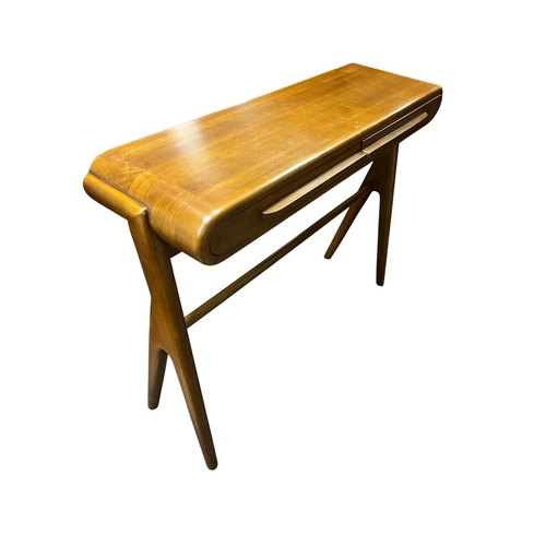 A MID-CENTURY DESIGN WALNUT CONSOLE TABLE the rounded rectangular top with twin frieze drawers featuring outcropped handles over twin split leg supports with turned stretcher 81cm (h) x 101cm (w) x 33cm (d)
