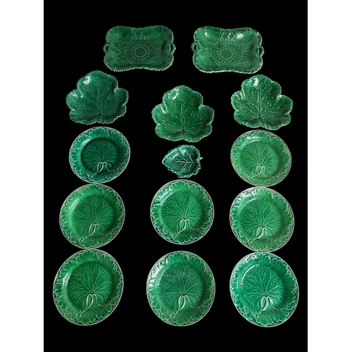 A COLLECTION OF WEDGWOOD MAJOLICA CABBAGEWARE comprising eight 'Etruria' circular plates, three leaf form dishes, a pair of shaped rectangular two handled serving platters 27cm (w) x 21cm (d) all impressed 'Wedgwood' to base and a small leaf shaped dish stamped to base (14) (AF)