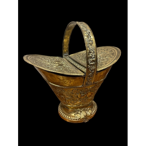 43 - A 19TH CENTURY BRASS ENGRAVED TRIVET of serpentine outline the shaped top with pierced apron raised ... 