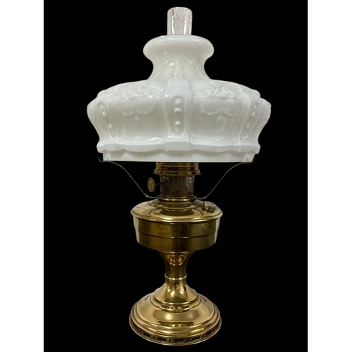 671 - AN ART DECO POLISHED BRASS KEROSENE TABLE LAMP 'Aladdin No. 11' complete with slip chimney and milk ... 