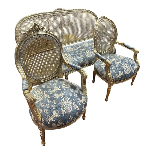 217 - A CONTINENTAL GILTWOOD AND UPHOLSTERED THREE PIECE SUITE comprising a two seater settee the ribboned... 