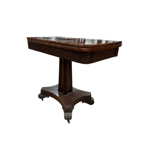 399 - A 19TH CENTURY MAHOGANY FOLDOVER SUPPER TABLE the rectangular hinged top above a faceted column on s... 