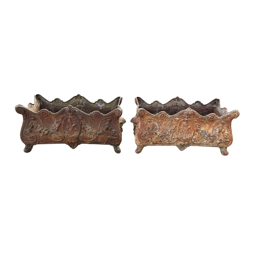 754 - A PAIR OF 19TH CENTURY FRENCH CAST IRON GARDEN PLANTERS with scrolled rims featuring flowerhead roun... 