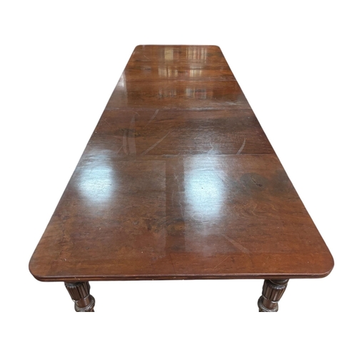 400 - A VERY FINE REGENCY MAHOGANY TELESCOPIC DINING TABLE with four loose leaves the rectangular top with... 
