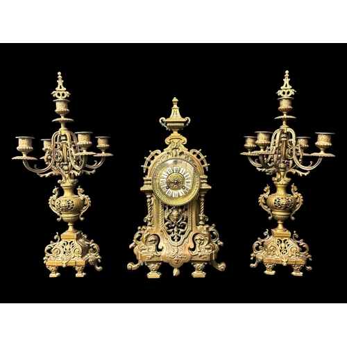 122 - A LATE 19TH CENTURY CONTINENTAL THREE PIECE MANTEL CLOCK GARNITURE of pierced architectural design w... 