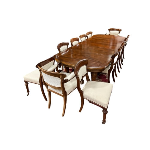 A VERY FINE THIRTEEN PIECE VICTORIAN MAHOGANY DINING ROOM SUITE comprising twelve chairs, including a pair of elbow chairs each with a curved top rail and upholstered panel and seat on baluster legs, the telescopic dining table of rectangular outline with rounded ends and three loose leaves on conforming legs 73cm (h) x fully extended 300cm (l) x 129cm (d) Each leaf 48cm (w)