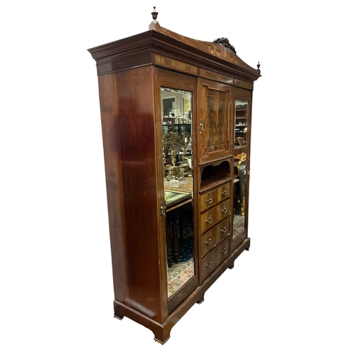 351 - AN EDWARDIAN MAHOGANY AND SATINWOOD INLAID COMBINATION WARDROBE the arched cornice with foliate and ... 