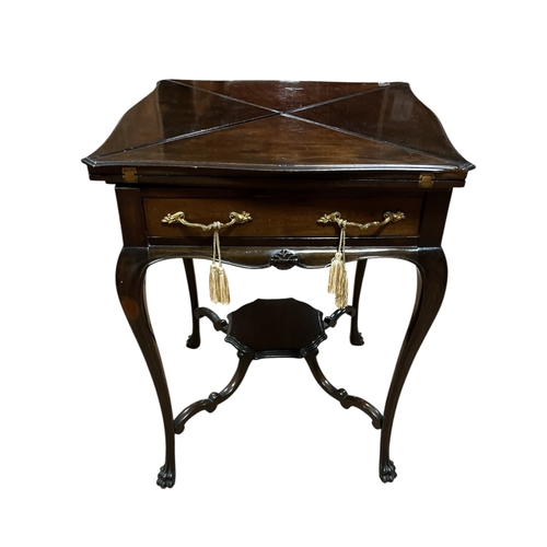 368 - AN EDWARDIAN MAHOGANY ENVELOPE CARD TABLE of serpentine outline the shaped top with hinged leaves co... 