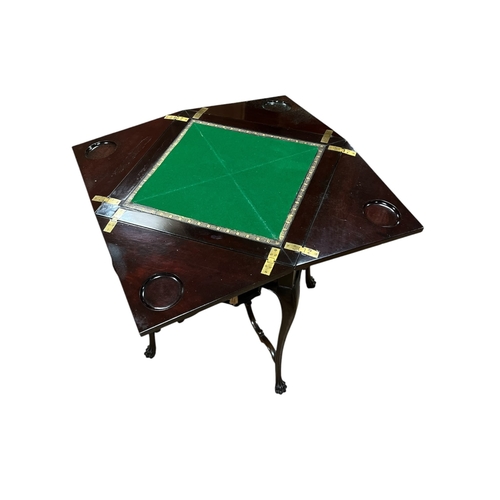 368 - AN EDWARDIAN MAHOGANY ENVELOPE CARD TABLE of serpentine outline the shaped top with hinged leaves co... 