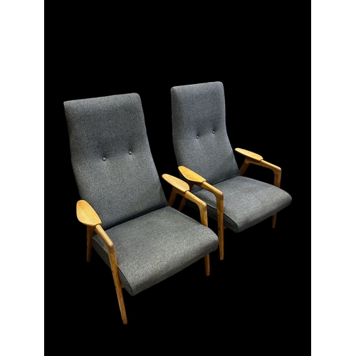 A PAIR OF SWEDISH MID-CENTURY YNGVE EKSTRÖM 'RUSTER' ARMCHAIRS upholstered in grey button back fabric and framed in solid oak with shaped and mounted arm rests (AF)