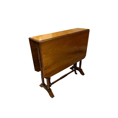 73 - AN EDWARDIAN SATIN BIRCH SUTHERLAND TABLE the rectangular hinged top raised on duel ring turned supp... 