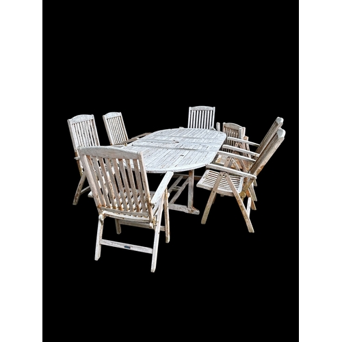 756 - AN EIGHT PIECE TIMBER PATIO SUITE comprising a D-end table 77cm (h) x 242cm (l) x 120cm (d) and seve... 