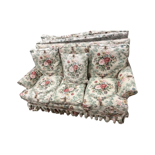 75A - A THREE SEATER SETTEE with loose cushions and scroll over arms with floral loose covers 183cm (w) (e... 