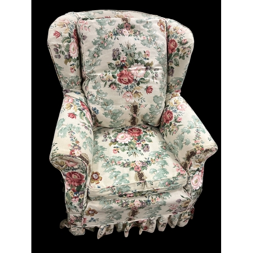 75B - A WING BACK EASY CHAIR with scroll over arms and floral loose cushion and covers