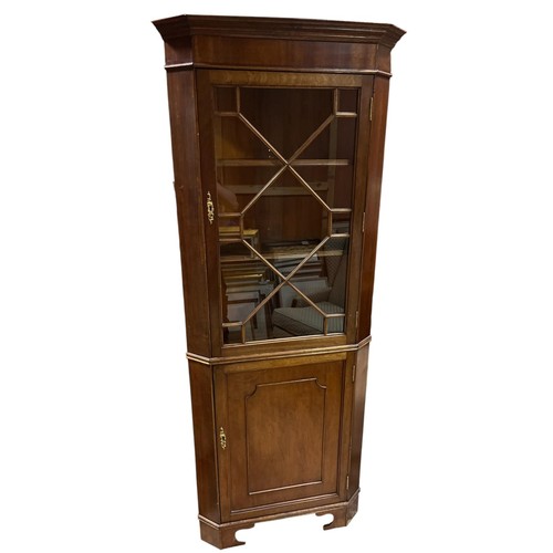 360 - A MAHOGANY CORNER CABINET the moulded cornice above an astragal glazed door with cupboard between ca... 