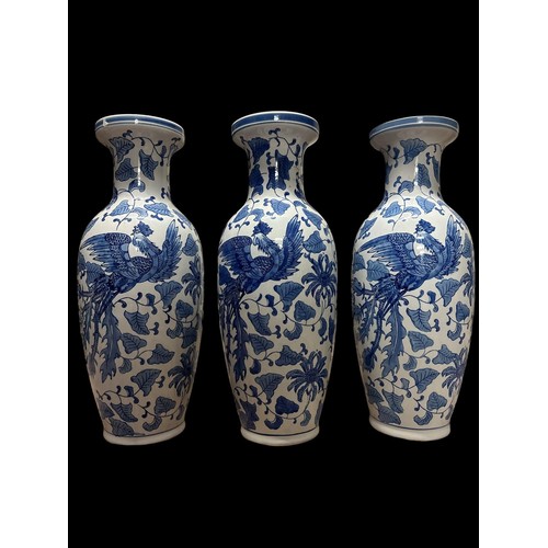 121 - A SET OF THREE CHINESE BLUE AND WHITE CERAMIC VASES with opposing dragon and phoenix decorations enc... 