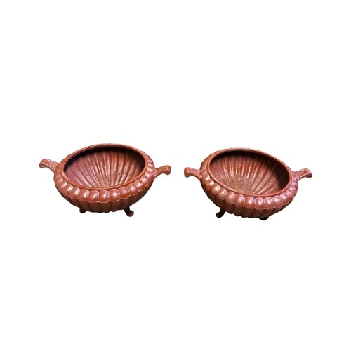 766 - A PAIR OF VICTORIAN STYLE CAST IRON PLANTERS each of semi lobed form with scroll handles on splayed ... 