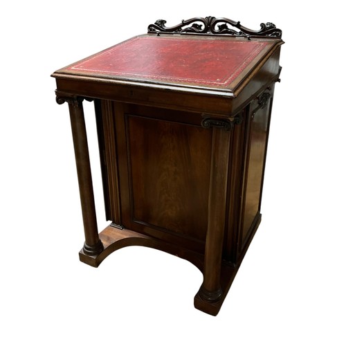 442 - A 19TH CENTURY MAHOGANY DAVENPORT the pierced foliate carved back above a hinged compartment with to... 