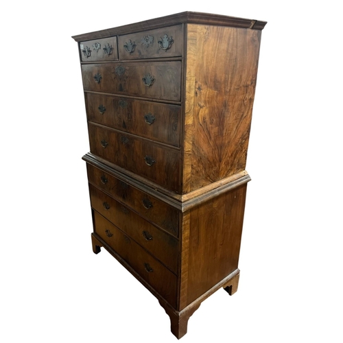 378 - AN EARLY WALNUT CROSSBANDED CHEST ON CHEST the moulded top above two short and three long graduated ... 