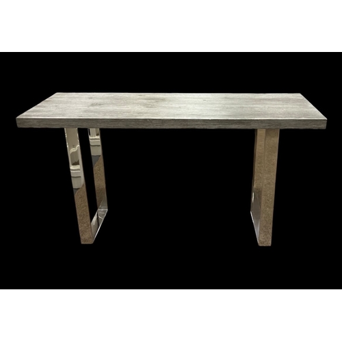 468 - A CONTEMPORARY HARDWOOD AND CHROME CONSOLE TABLE the rectangular top with glass saver raised atop co... 