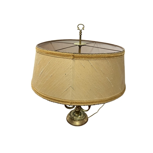 109 - A VINTAGE GILT BRASS THREE BRANCH TABLE LAMP the pierced handle atop a slender stem with large conic... 