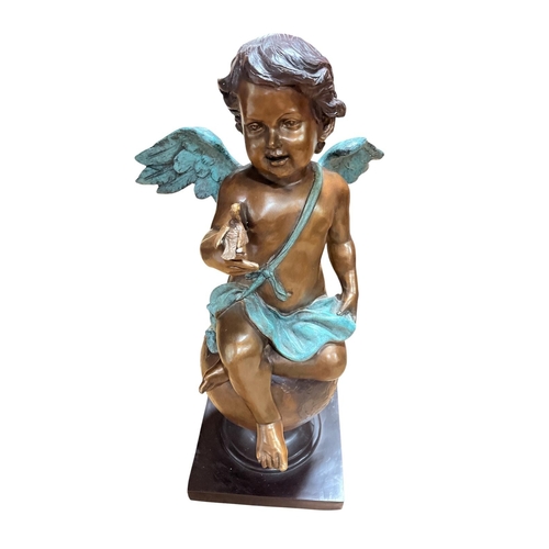 66 - A FINE BRONZE FIGURE modelled as a winged cherub shown seated on a globe holding a bird raised on a ... 