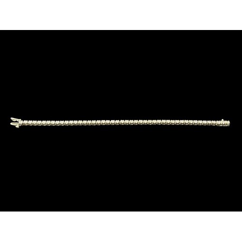 519F - A 14CT WHITE GOLD TENNIS BRACELET inset with forty-six diamonds 14g