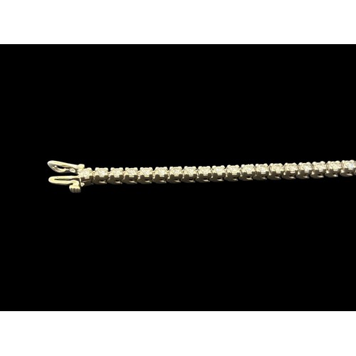 519F - A 14CT WHITE GOLD TENNIS BRACELET inset with forty-six diamonds 14g