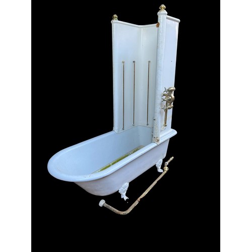 792 - A 19TH CENTURY CAST IRON CLAW FOOT BATHTUB of elongated form with flared rim over tapered body raise... 