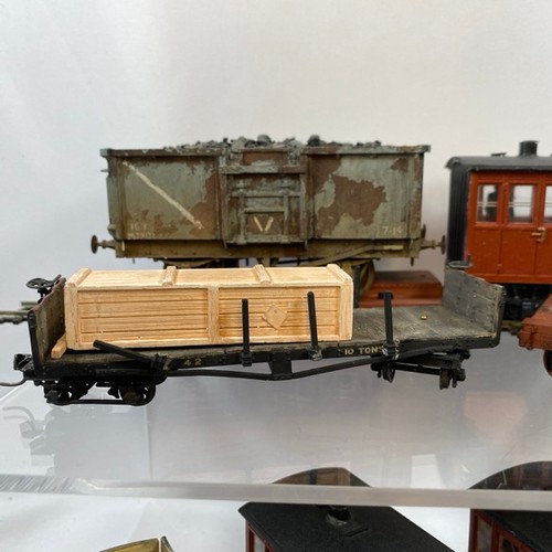 378 - 11 On16.5 wagons/coaches some with figures and another flat-bed transporting an O gauge coal wagon, ... 